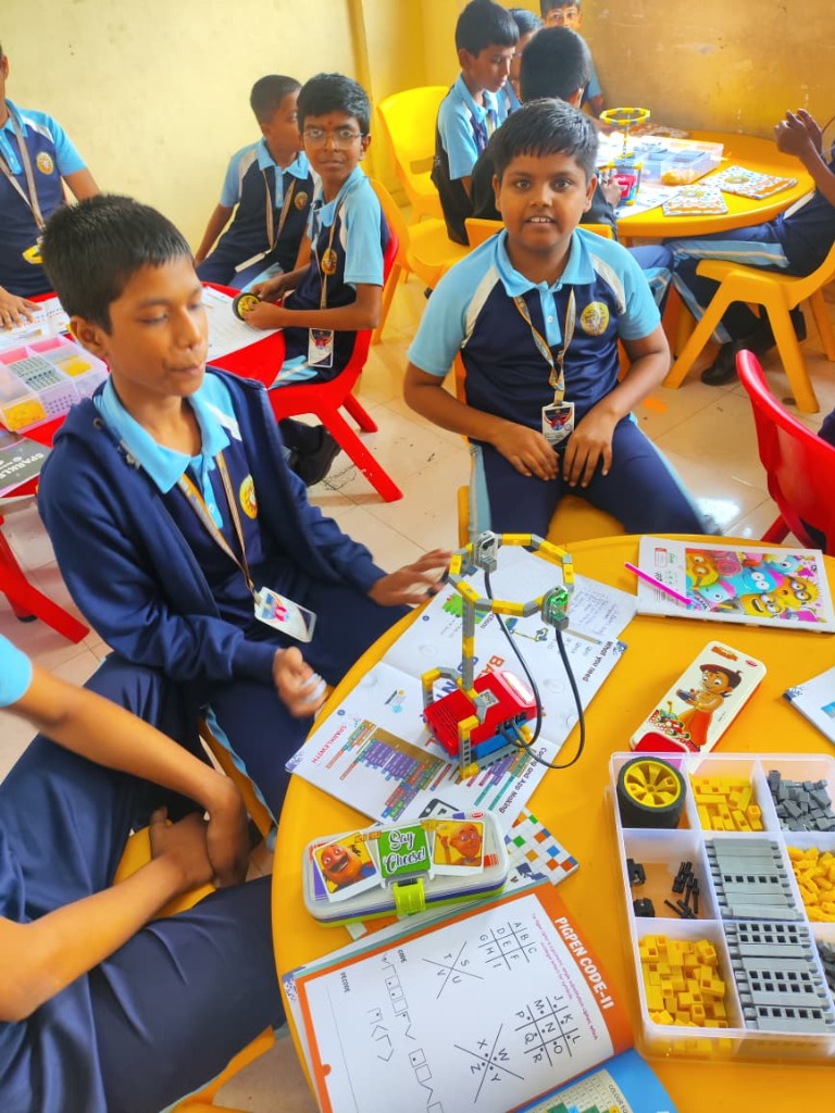 Student groups assembling robotics models